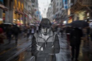 Guy standing in middle of street with everything around him in a blur