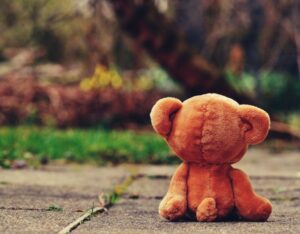 Cuddly toy bear on pavement