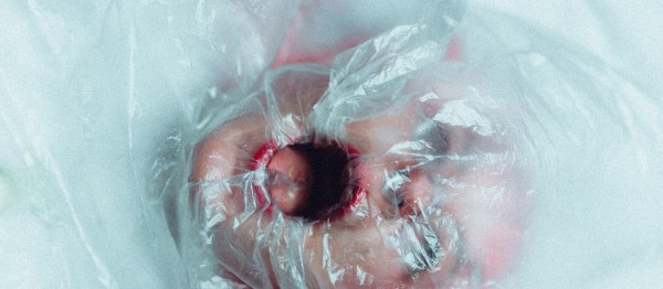 Girl who can't breathe with plastic over her face