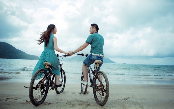 couple connecting on bicycles