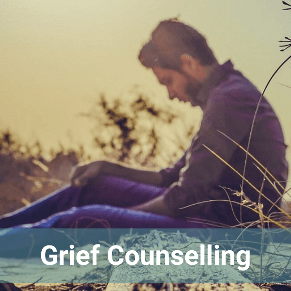 man sitting and grieving