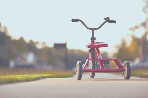 childs red tricycle