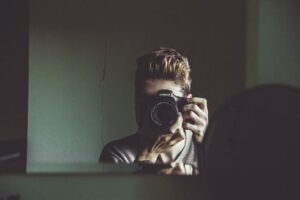 man taking photo of himself in mirror
