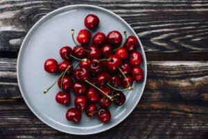 red cherries in a plate on a table